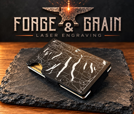 Custom engraved aluminum wallet on black slate with Forge & Grain laser engraving backdrop